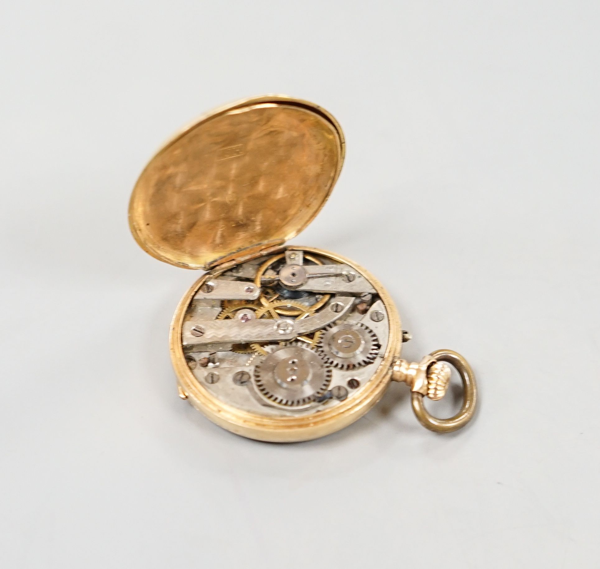 A continental 18k and enamelled open face keyless fob watch, decorated with a young boy hunting, case diameter 30mm